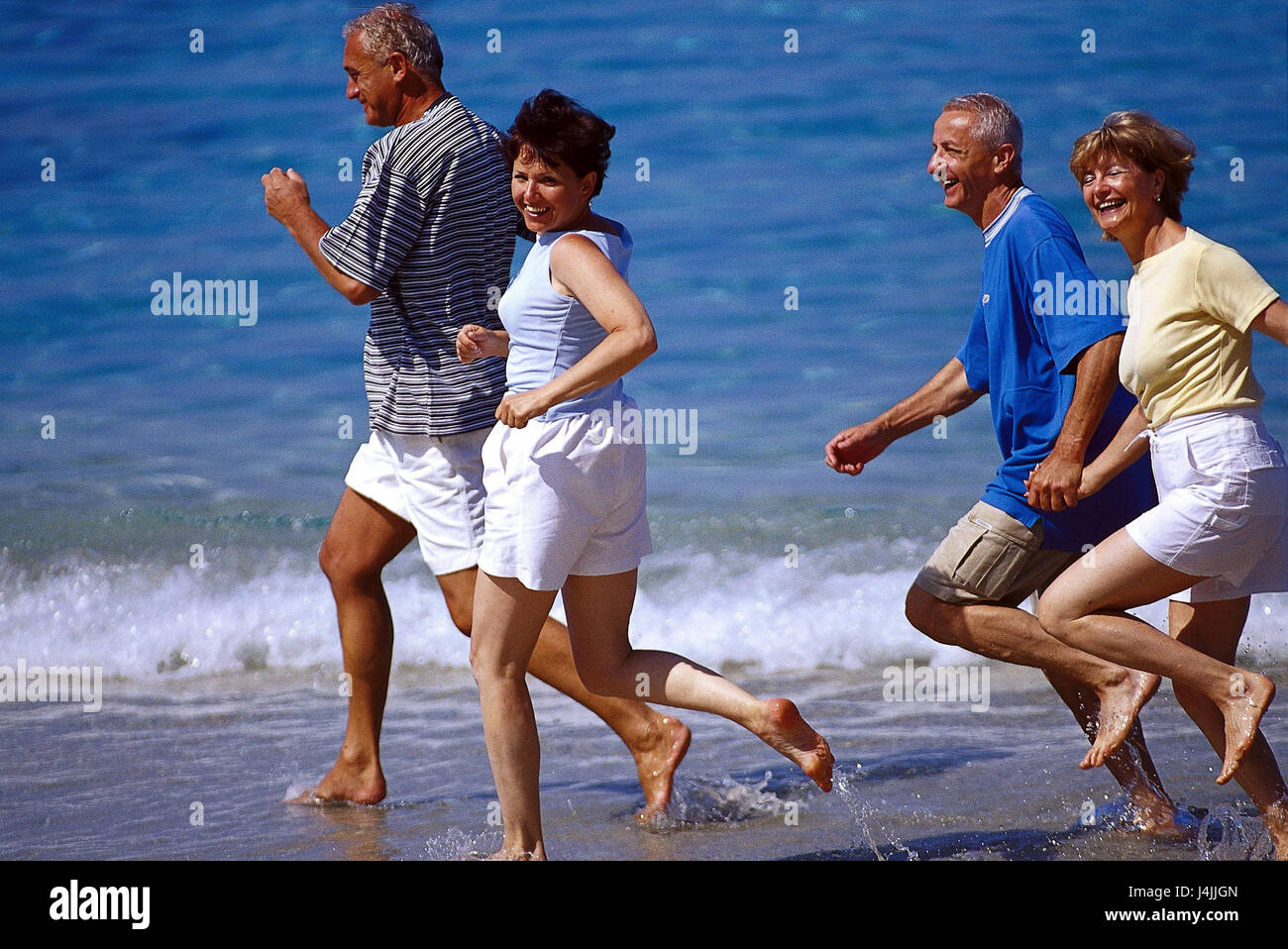 Couples, middle old person, beach run outside, summer, vacation, leisure time, lifestyle, four, friends, together, fun, happily, tuning, positively, sport, sportily, beach, sea, run, jog, jogging, fit fitness, agile, motion, activity, leisurewear Stock Photo