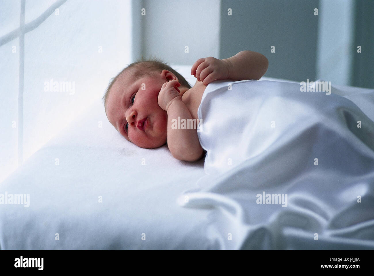 Bed, baby, lie very closely, child, infant, baby, rest, back position, covered, silk caps Stock Photo