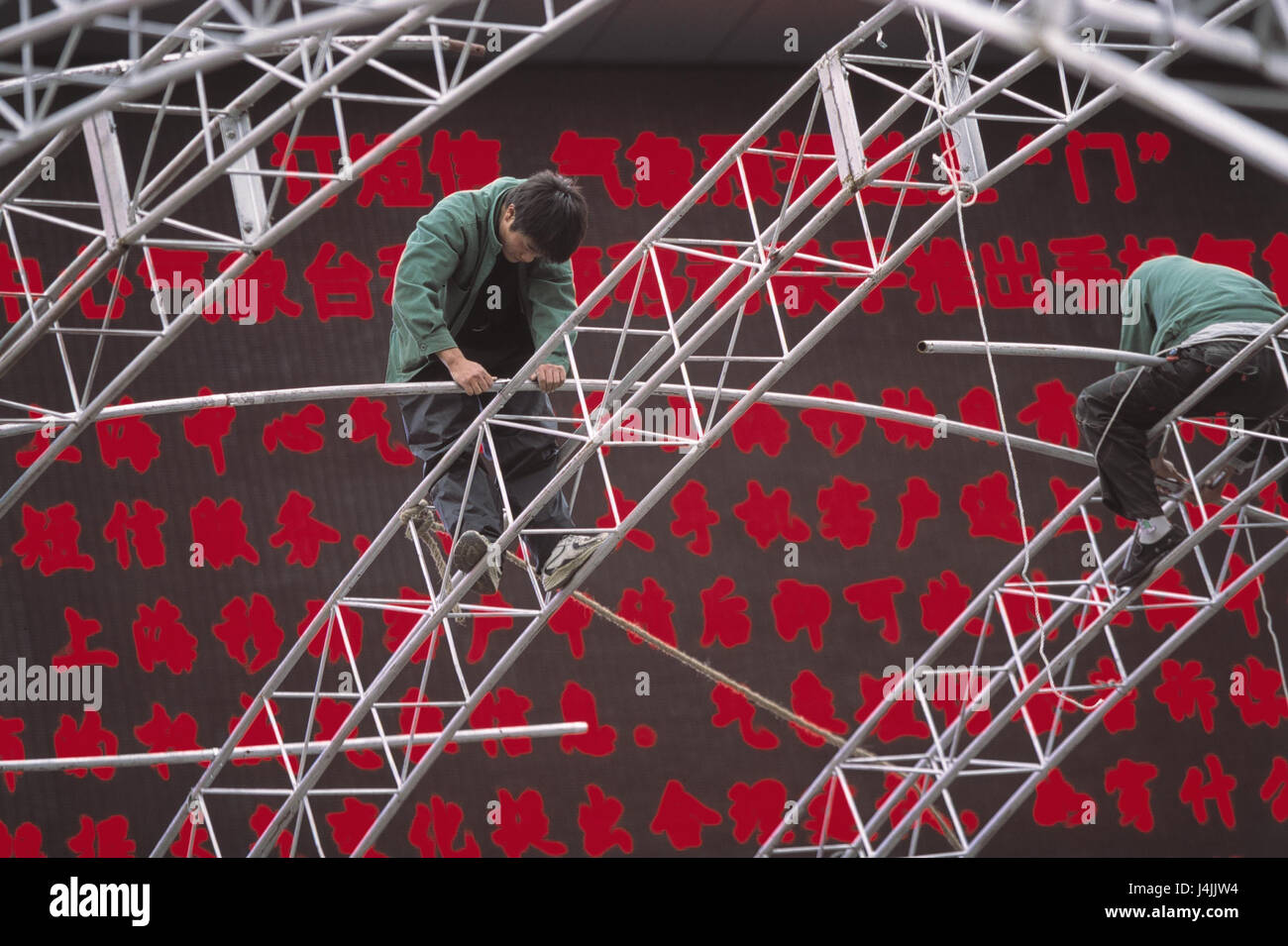 China, Shanghai, Nanjing Donglu, tent construction, worker, videowall no model release, Asia, Eastern China, Shanghai, men, two, tent, fixed tent, build up, editing worker, have a good head for heights, balancing act, scaffolding, iron scaffolding, tent sticks Stock Photo