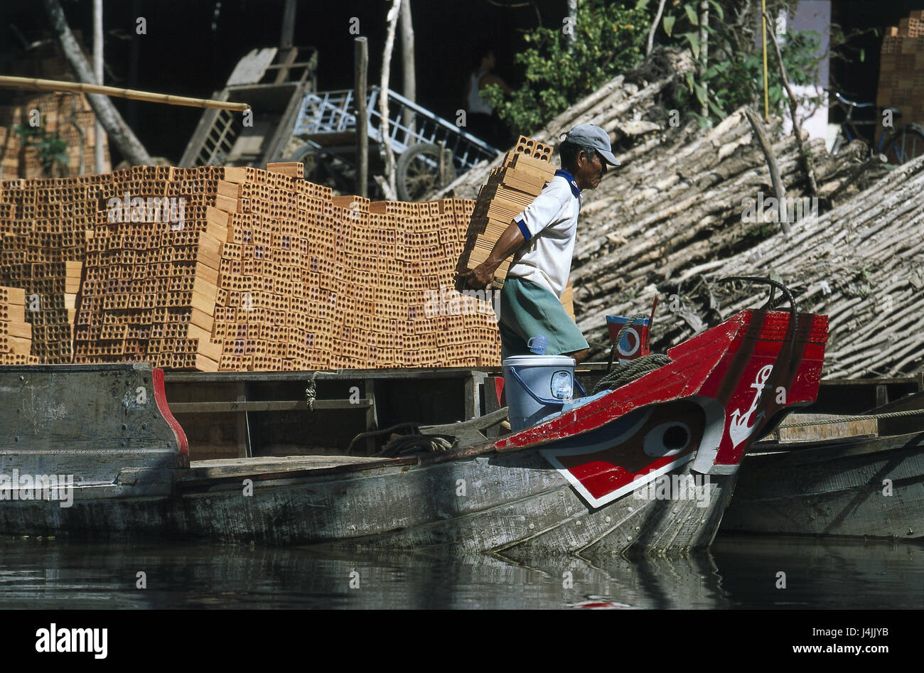 Vietnam, Mekong delta, Can Tho, transport ship, worker, red bricks, off-load no model release, South-East Asia, river, waters, transport, delivery, clay brick, building materials, carry, work, outside Stock Photo