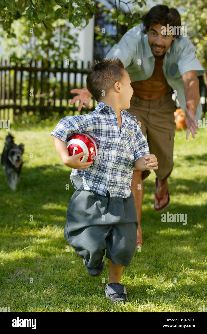 Garden, father, boy, to ball games, run, play happily family, child, son, ball, run, run away, trap, fun, joy, cheerfulness, motion, activity, fitness, health, family life, family luck, happily, leisure time, holidays, summers Stock Photo