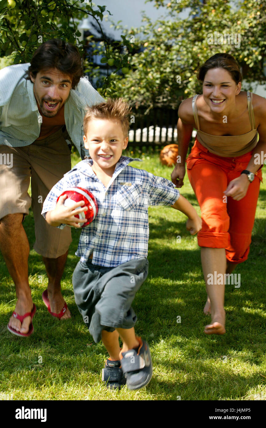 Garden, parents, boy, to ball games, run, play happily family, child, son, ball, run, run away, trap, fun, joy, cheerfulness, motion, activity, fitness, health, family life, family luck, leisure time, holidays, summers Stock Photo