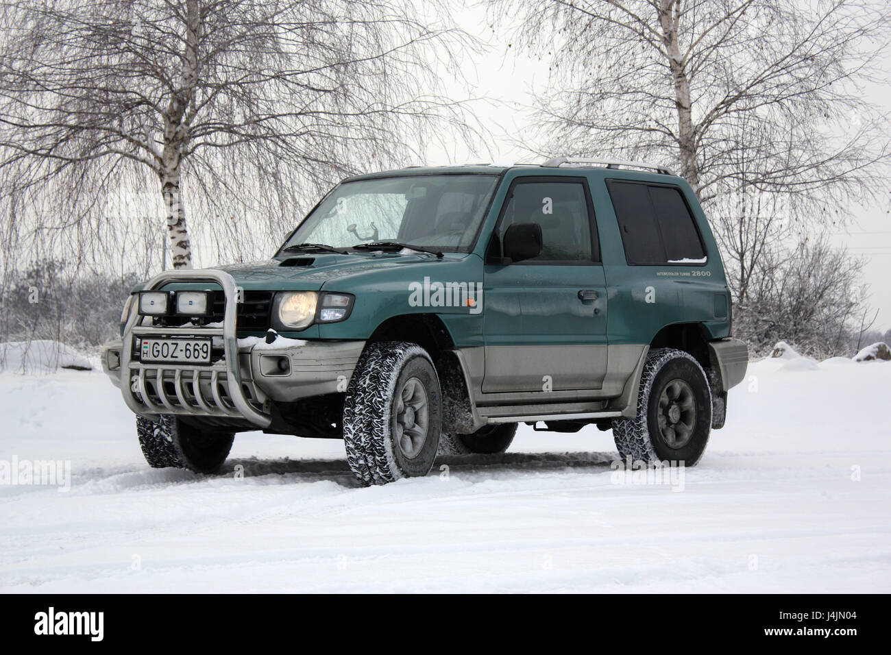BUDAPEST, HUNGARY - DECEMBER 19, 2010: Dirty Mitsubishi Pajero (1998) standing in the snow on December 19, 2010 in Budapest, Hungary. Stock Photo