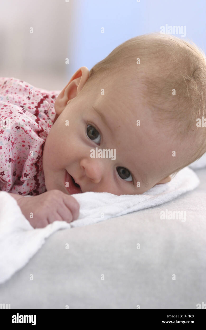 Baby, lie, observe, portrait child, small, 4 months, infant, blond, girls, dress, abdominal position, brightly, carefully, interest, curiosity, inside, conception, childhood, attention, Stock Photo