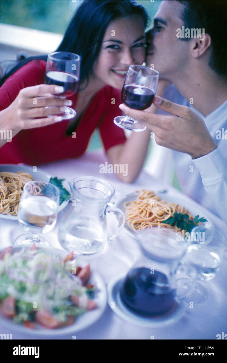Restaurant, couple, kiss, cheek, wineglasses, spaghetti inside, bar