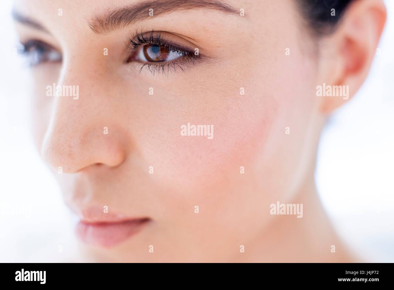 Young woman with brown eyes, close up portrait. Stock Photo