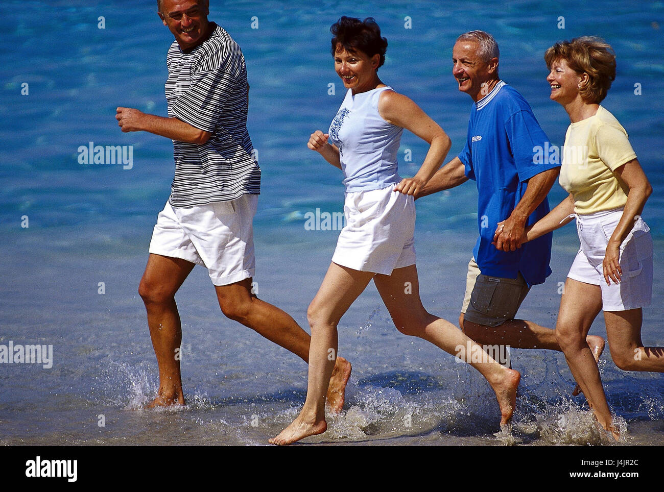 Couples, middle old person, beach run outside, summer, vacation, leisure time, lifestyle, four, friends, together, fun, happily, tuning, positively, sport, sportily, beach, sea, run, jog, jogging, fit fitness, agile, motion, activity, leisurewear Stock Photo