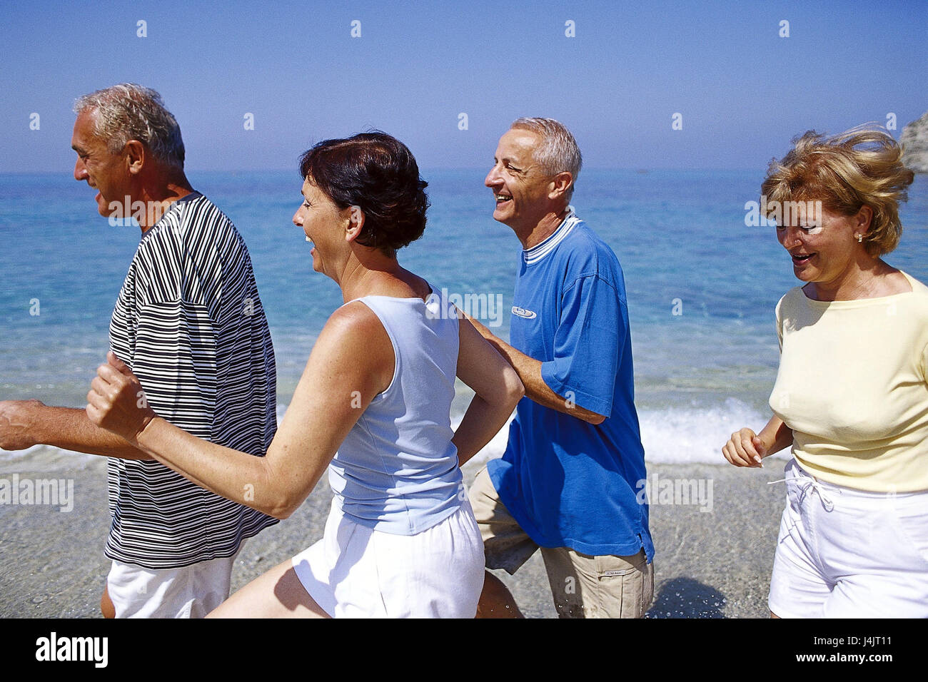 Couples, middle old person, beach run, half portrait outside, summer, vacation, leisure time, lifestyle, four, friends, together, fun, happily, tuning, positively, sport, sportily, beach, sea, run, jog, jogging, fit fitness, agile, motion, activity, leisurewear Stock Photo
