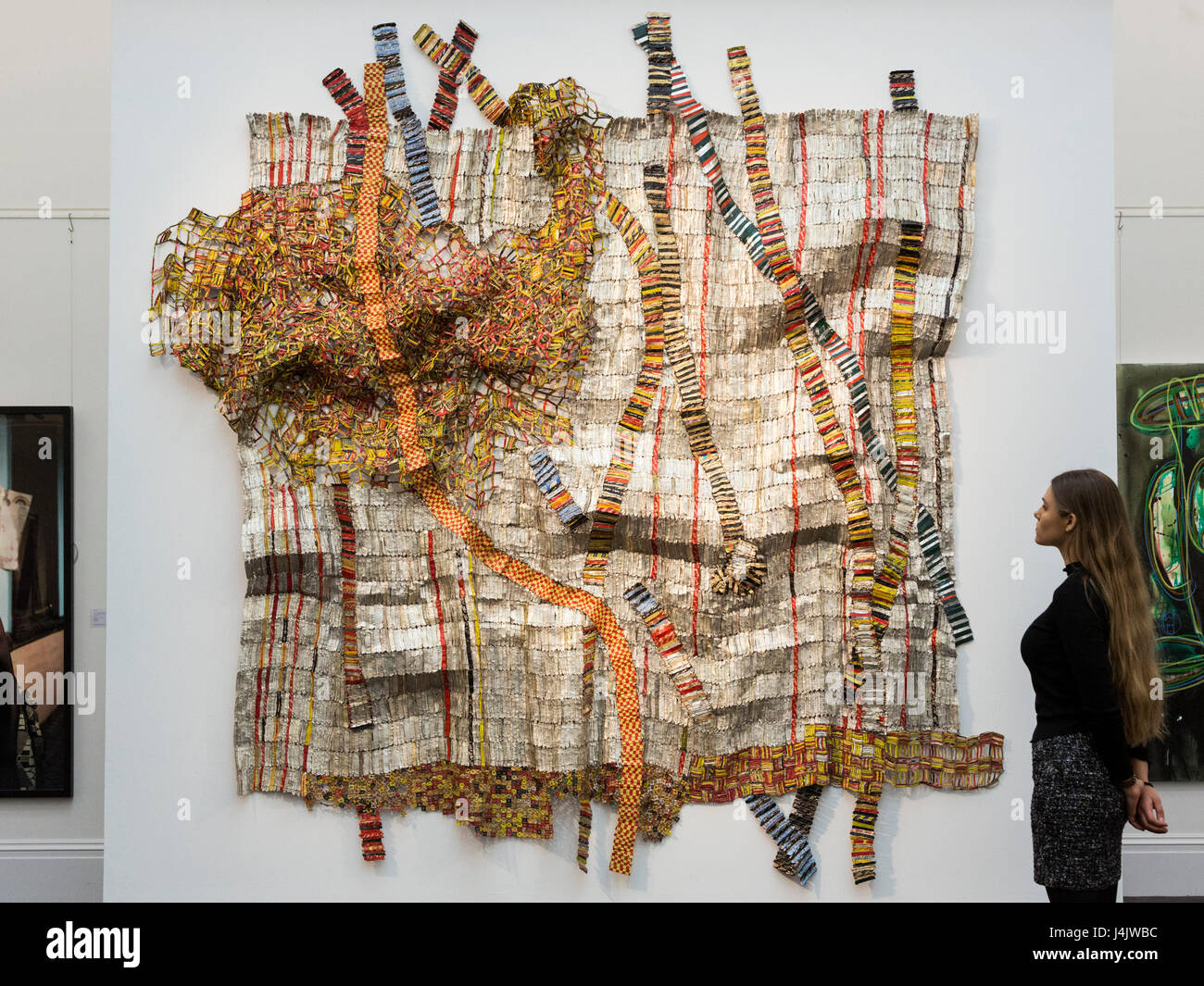 London, UK. 12 May 2017. Earth Developing More Roots, 2011, by artist El Anatsui from Ghana, est GBP 650,000-850,000. Sotheby’s unveils inaugural sale of modern and contemporary African art at its New Bond Street premises. 115 artworks by over 60 different artists from 14 countries across the continent are on display until the sale on 16 May 2017. Stock Photo