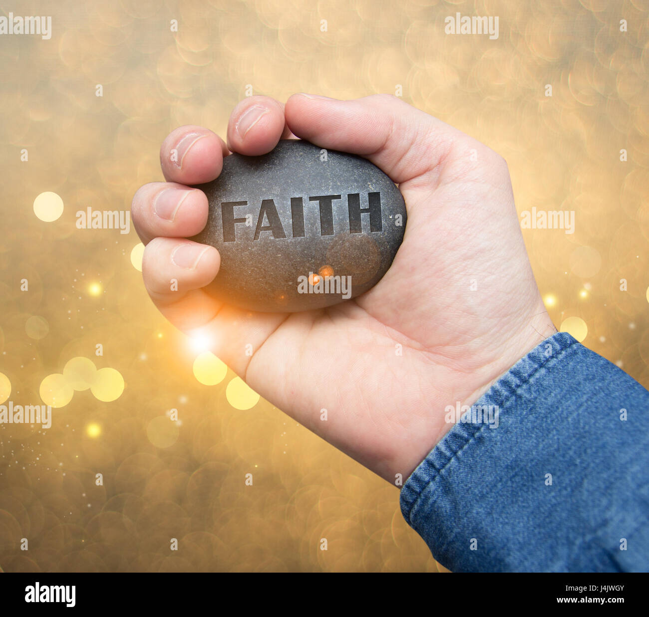 faith stone in hand Stock Photo