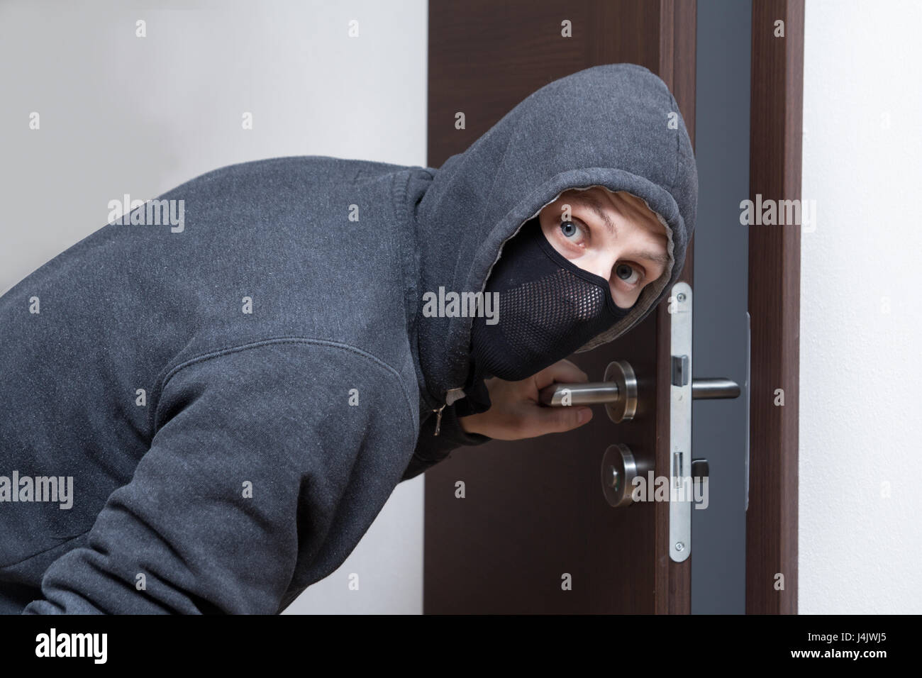 thief opening door Stock Photo