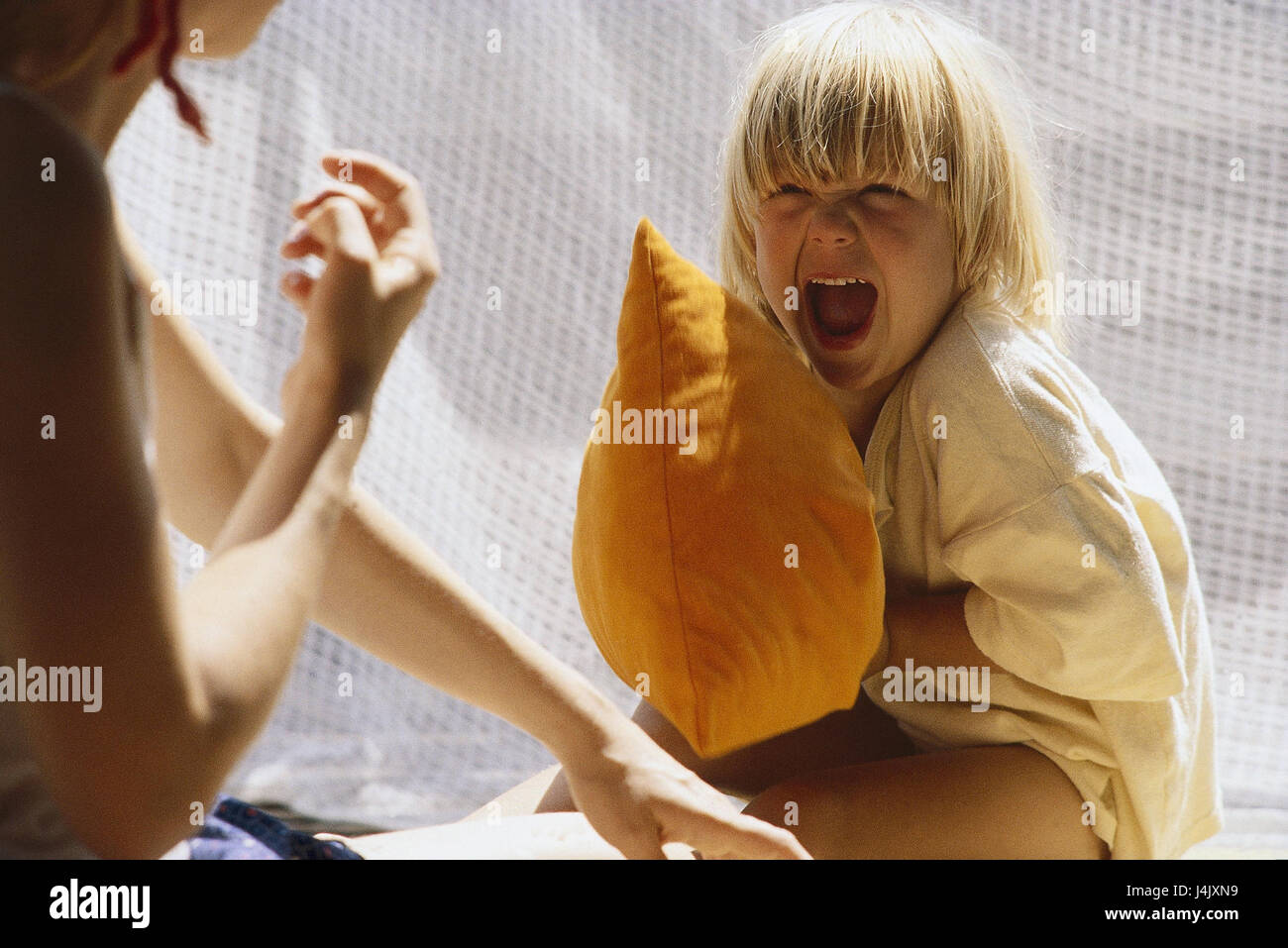 Children, argue, shout at cushion battle, at detail nut, boy, girl, siblings, fight, conflict, aggressively Stock Photo