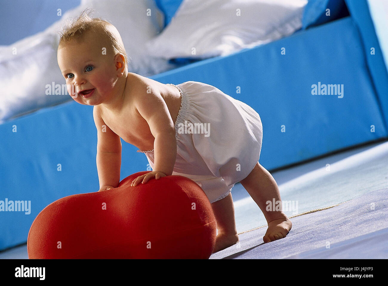 Baby, happily, nappy trousers, standing attempt, hassock, add support inside, at home, child, infant, cheerfully, brightly, learn stand, to go, try, try, pride, upper parts of the body freely Stock Photo