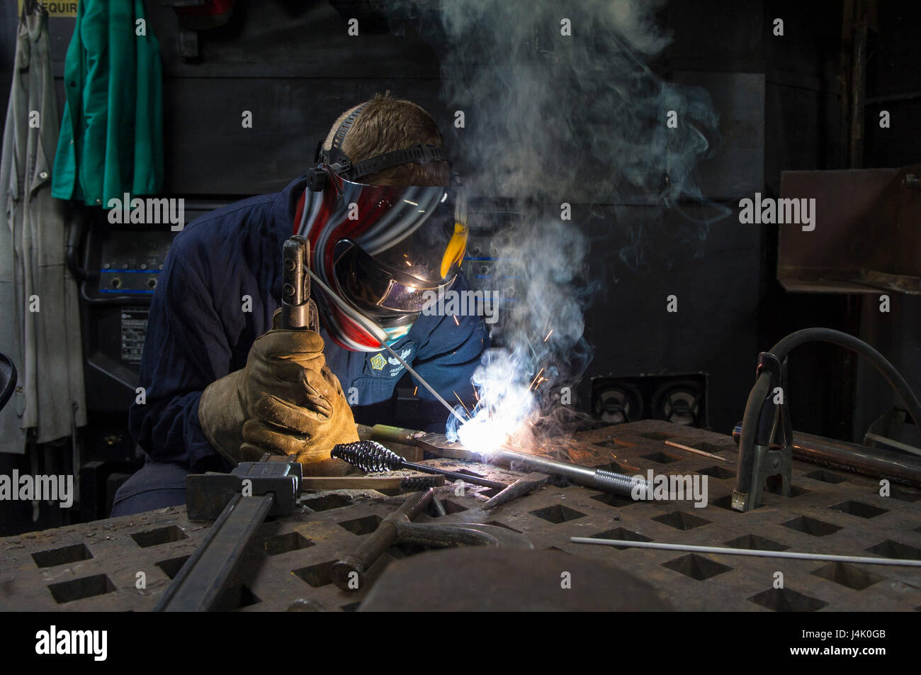 161001-N-WS581-053  ARABIAN GULF (Oct. 01, 2016) Petty Officer 3rd Class Jacob Keller, from Marshall, Ill., welds together an arm for a ballistic door in the repair shop of the aircraft carrier USS Dwight D. Eisenhower (CVN 69) (Ike). Keller serves aboard Ike as a hull maintenance technician and is responsible for metal work on the ship. Ike and its Carrier Strike Group are deployed in support of Operation Inherent Resolve, maritime security operations and theater security cooperation efforts in the U.S. 5th Fleet area of operations. (U.S. Navy photo by Petty Officer 3rd Class Andrew J. Sneeri Stock Photo
