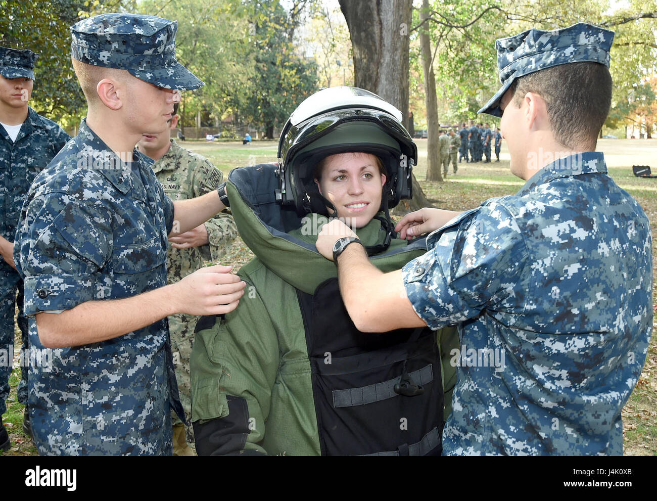 161105-N-IK959-325  NASHVILLE, Tenn. (Nov. 4, 2016) Vanderbilt University Naval Reserve Officers Training Corps (NROTC) Midshipman 2nd Class, Maddie Hoffman is “suited up” in an EOD9 Bomb Suit by Midshipman 4th Class Alex McLaren, right, and Midshipman 3rd Class Nicholas Piccioli on the Vanderbilt campus. Vanderbilt NROTC hosted an Explosive Ordnance Disposal (EOD) “Exceptional Exposure” weekend for more than 40 NROTC midshipmen from units around the country. (U.S. Navy image by Scott A. Thornbloom/Released) Stock Photo