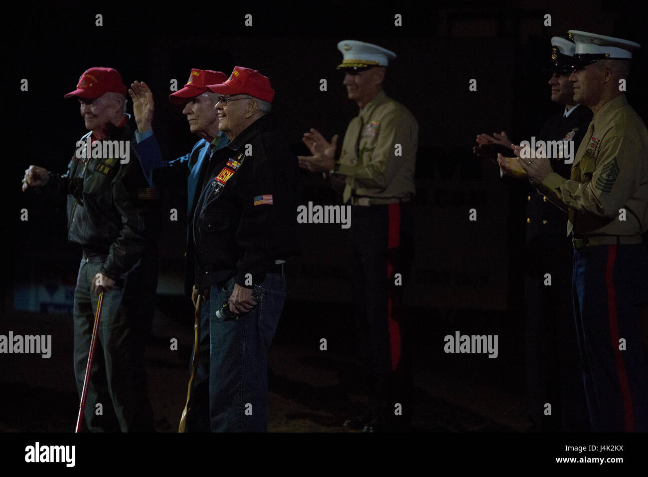 World War II veterans accept a standing ovation during the closing ceremony of the National Western Stock Show in Denver, Jan. 17, 2017, as leaders of Marine Forces Reserve show their support in appreciation for the sacrifices the men made for their country. The NWSS honored veterans to show their dedication to the military and to bring attention to the 100th anniversary of the Marine Corps Reserves. (U.S. Marine Corps photo by Lance Cpl. Dallas Johnson/Released) Stock Photo