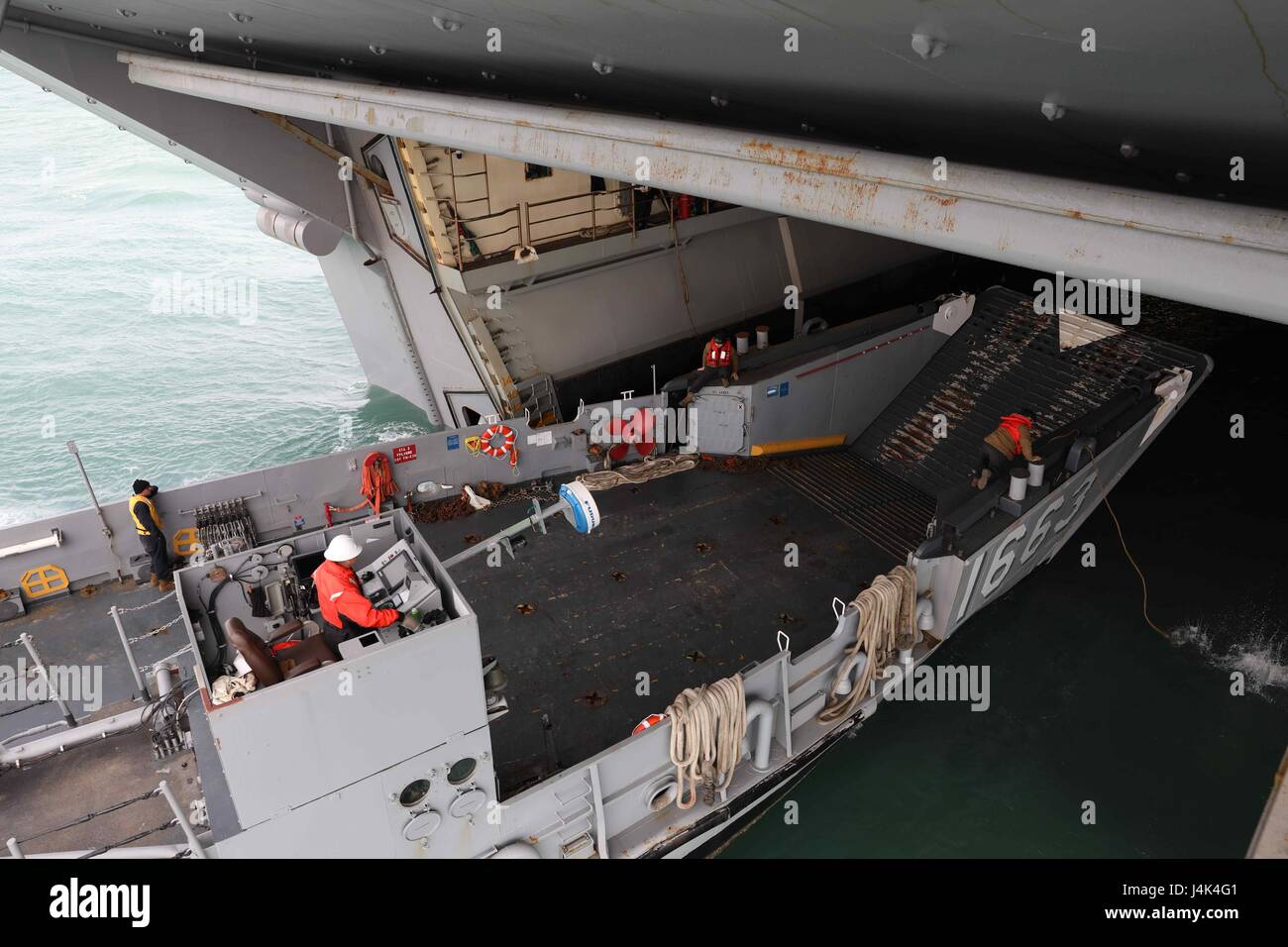 A landing craft utility exits the well deck of the amphibious assault ...