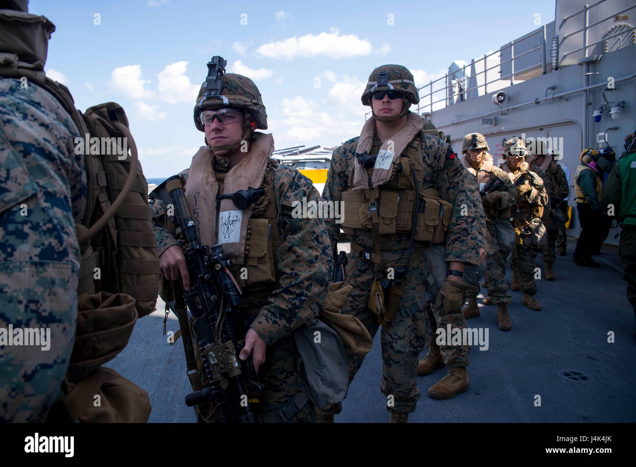 170315-N-TH560-136 PHILIPPINE SEA (March 15, 2017) Marines, assigned to the 31st Marine Expeditionary Unit (MEU), embark a CH-53E Super Stallion, assigned to the “Flying Tigers” of Marine Medium Tiltrotor Squadron (VMM) 262, on the flight deck of amphibious assault ship USS Bonhomme Richard (LHD 6) during a tactical recovery of aircraft and personnel (TRAP) exercise in support of amphibious integration training (AIT). AIT is designed to integrate all elements of the Bonhomme Richard Expeditionary Strike Group (BHR ESG) and the 31st MEU to test their ability to plan for and execute mission esse Stock Photo