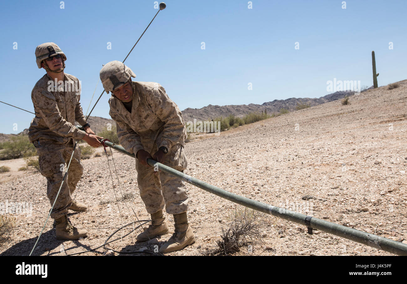U.S. Marines with Headquarters and Services Company, 2nd Battalion, 6th Marine Regiment, 2nd Marine Division (2d MARDIV), set up communication towers prior to the start of a battalion-level defensive position for Talon Exercise (TalonEx) 2-17, Yuma, A.Z., April 18, 2017. The purpose of TalonEx was for ground combat units to conduct integrated training in support of the Weapons and Tactics Instructor Course (WTI) 2-17 hosted by Marine Aviation Weapons and Tactics Squadron One (MAWTS-1). Stock Photo