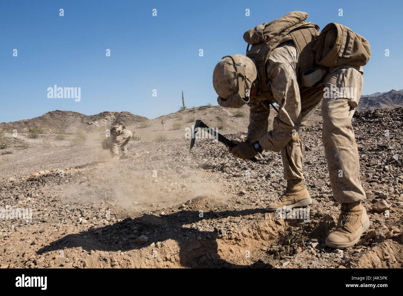 U.S. Marine Corps Lance Cpl. Zachary R. Thompson, a rifleman with Echo Company, 2nd Battalion, 6th Marine Regiment, 2nd Marine Division (2d MARDIV), digs his skirmisher fighting position during a battalion-level defensive position for Talon Exercise (TalonEx) 2-17, Yuma, A.Z., April 18, 2017. The purpose of TalonEx was for ground combat units to conduct integrated training in support of the Weapons and Tactics Instructor Course (WTI) 2-17 hosted by Marine Aviation Weapons and Tactics Squadron One (MAWTS-1). Stock Photo