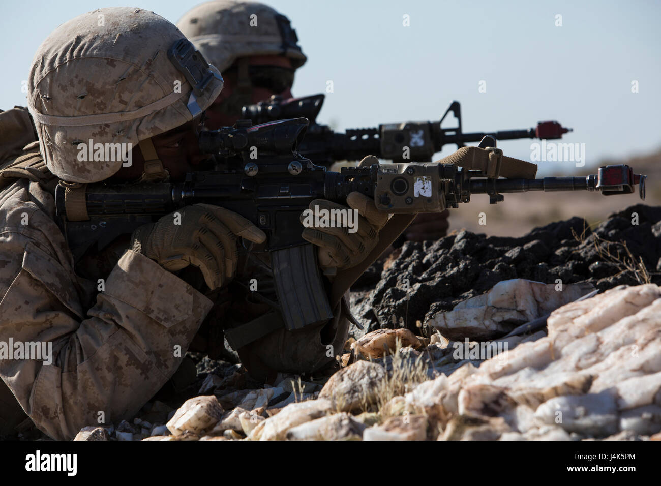 U.S. Marine Corps Pfc. Tahje S. Hodge, a rifleman with Fox Company, 2nd Battalion, 6th Marine Regiment, 2nd Marine Division (2d MARDIV), sights in on his M4A1 Carbine rifle during a battalion-level defensive position for Talon Exercise (TalonEx) 2-17, Yuma, A.Z., April 18, 2017. The purpose of TalonEx was for ground combat units to conduct integrated training in support of the Weapons and Tactics Instructor Course (WTI) 2-17 hosted by Marine Aviation Weapons and Tactics Squadron One (MAWTS-1). Stock Photo