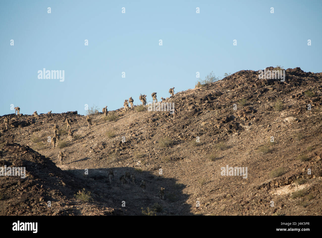 U.S. Marines with 2nd Battalion, 6th Marine Regiment, 2nd Marine Division (2d MARDIV), scale up a hill for a battalion-level defensive position for Talon Exercise (TalonEx) 2-17, Yuma, A.Z., April 18, 2017. The purpose of TalonEx was for ground combat units to conduct integrated training in support of the Weapons and Tactics Instructor Course (WTI) 2-17 hosted by Marine Aviation Weapons and Tactics Squadron One (MAWTS-1). Stock Photo