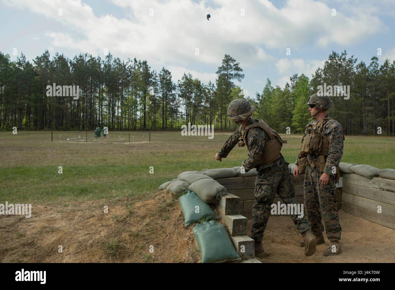 A Marine throws an M69 training grenade during a grenade range at Fort
