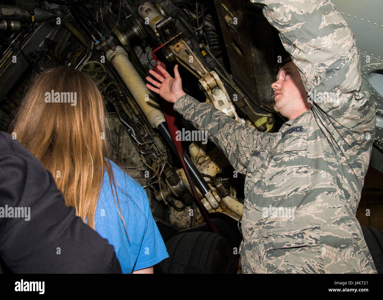 Senior Airman Joshua Suter, 5th Aircraft Maintenance Squadron crew chief, explains a B-52H Stratofortress’s landing gear during a tour at Minot Air Force Base, N.D., May 1, 2017. The 5th AMXS Airmen taught Edison Elementary School’s science, technology, engineering and math girls about the aircraft’s mission and features. (U.S. Air Force photo/Airman 1st Class Alyssa M. Akers) Stock Photo