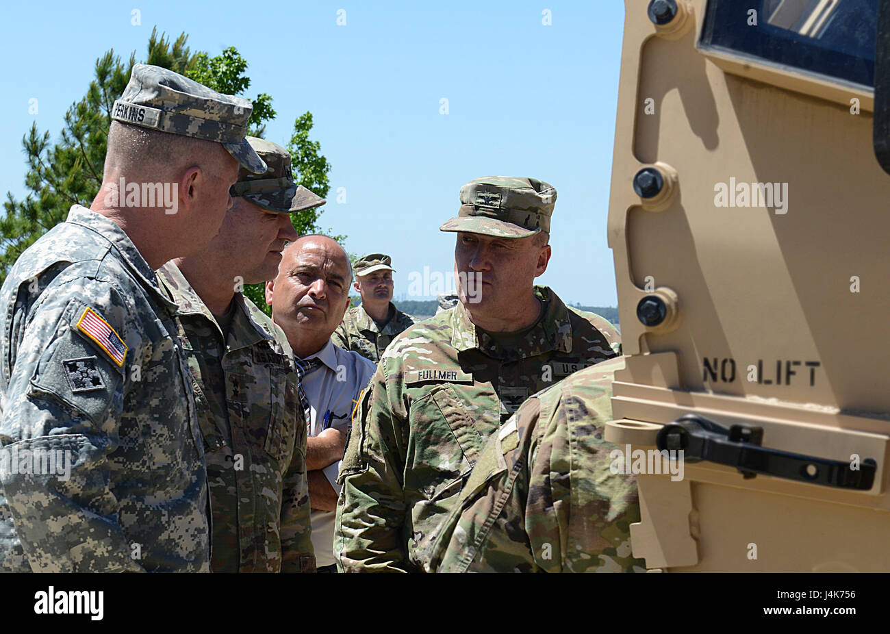 U.S. Army Gen. David Perkins, commanding general, U.S. Army Training and Doctrine Command, and  Maj. Gen. Bo Dyess, Army Capabilities Integration Center director, are briefed by Col. Shane Fullmer, JLTV joint project manager on a production model Joint Light Tactical Vehicle at Joint Base Langley-Eustis, Va., May 2, 2017. The JLTV program is an Army-led agenda collaborating with the U.S. Marine Corps to replace a portion of each branch's light tactical vehicle fleets.  (U.S. Air Force photo/Staff Sgt. Teresa J. Cleveland) Stock Photo