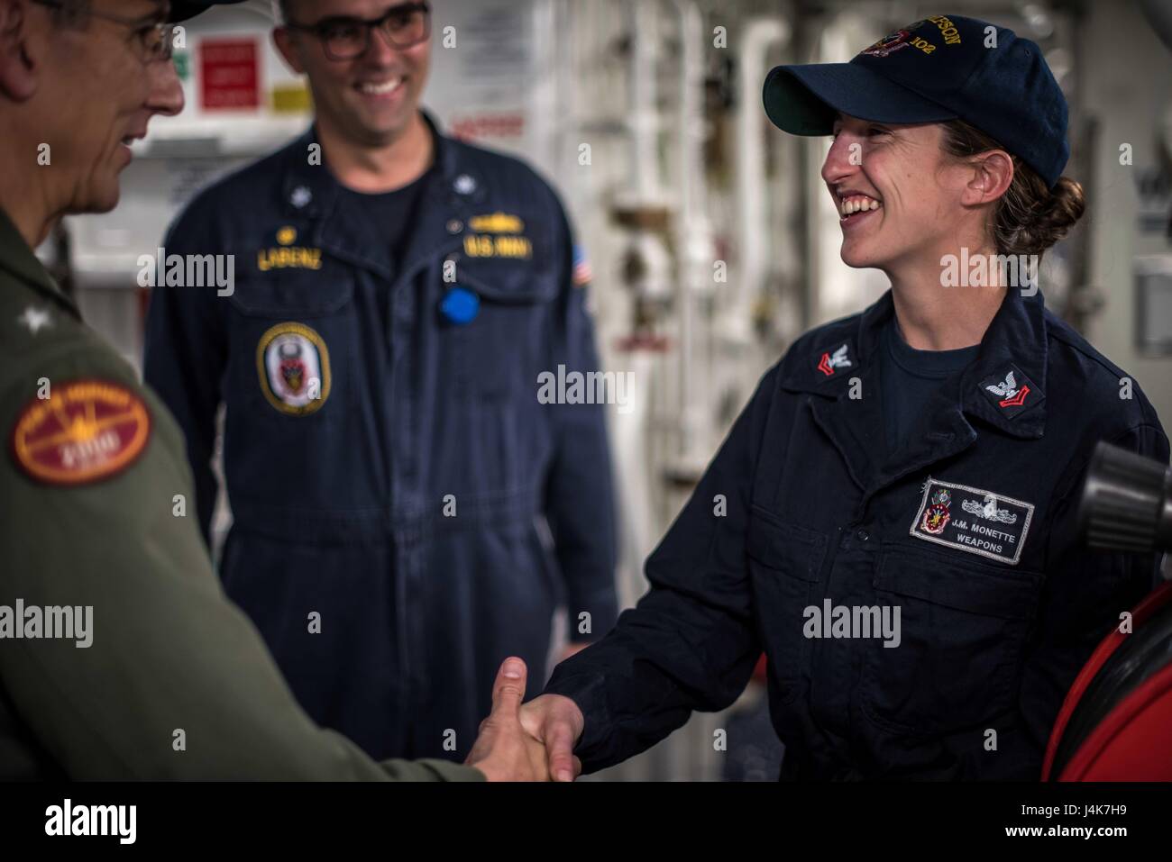 170503-N-TV230-243 PACIFIC OCEAN (May 3, 2017) A Sailor receives a challenge coin from Rear Adm. James Bynum, commander of Carrier Strike Group (CCSG) 9 aboard the guided-missile destroyer USS Sampson (DDG) 102, during a Group Sail training unit exercise (GRUSL) with the Theodore Roosevelt Carrier strike Group (TRCSG). GRUSL is the first step in the Theodore Roosevelt’s integrated training phase and aims to enhance mission-readiness and warfighting capabilities between the ships, airwing and the staffs of the TRCSG through simulated real-world scenarios. (U.S. Navy Photo by Mass Communication  Stock Photo