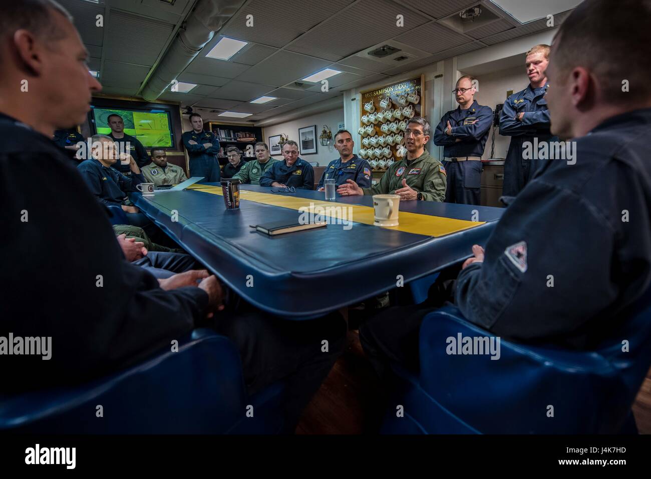 170503-N-TV230-259 PACIFIC OCEAN (May 3, 2017) Rear Adm. James Bynum, commander of Carrier Strike Group (CCSG) 9 addresses the Wardroom of the guided-missile destroyer USS Sampson (DDG) 102, during a Group Sail training unit exercise (GRUSL) with the Theodore Roosevelt Carrier strike Group (TRCSG). GRUSL is the first step in the Theodore Roosevelt’s integrated training phase and aims to enhance mission-readiness and warfighting capabilities between the ships, airwing and the staffs of the TRCSG through simulated real-world scenarios. (U.S. Navy Photo by Mass Communication Specialist Seaman Bil Stock Photo