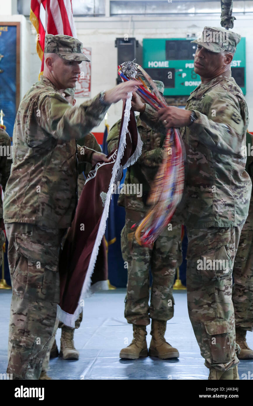 Col. George Kyle (right), the commander of the 31st Combat Support Hospital, and Command Sgt. Maj. Robert Nelson, the command sergeant major for the 31st CSH, cases the unit’s colors, during a transfer of authority ceremony, in the Zone 1 Fitness Center, Camp Arifjan, May 5. The ceremony transferred the authority of the United States Military Hospital- Kuwait from the 31st CSH to the 86th CSH. (U.S. Army photo by Sgt. Bethany Huff, ARCENT Public Affairs) Stock Photo