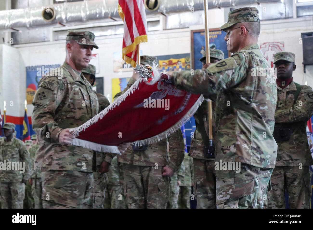 Col. Bruce Syvinski (right), the commander of the 86th Combat Support Hospital, and Command Sgt. Maj. Daryl Forsythe, the command sergeant major for the 86th CSH, uncases the unit’s colors, during the transfer of authority ceremony, in the Zone 1 Fitness Center, Camp Arifjan, Kuwait, May 5. The ceremony marked the last deployment for the 86th CSH, as it will re-designate into a field hospital when it returns from this rotation. (U.S. Army photo by Sgt. Bethany Huff, ARCENT Public Affairs) Stock Photo