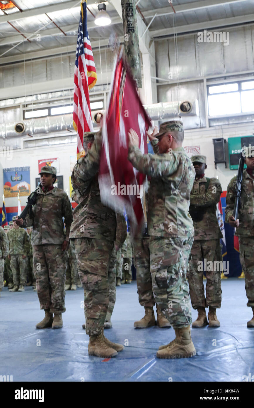 Col. Bruce Syvinski (right), the commander of the 86th Combat Support Hospital, and Command Sgt. Maj. Daryl Forsythe, the command sergeant major for the 86th CSH, releases the unit’s colors to their upright position, during the transfer of authority ceremony, in the Zone 1 Fitness Center, Camp Arifjan, Kuwait, May 5. The ceremony transfers the authority of the United States Military Hospital- Kuwait from the 31st CSH to the 86th CSH. (U.S. Army photo by Sgt. Bethany Huff, ARCENT Public Affairs) Stock Photo