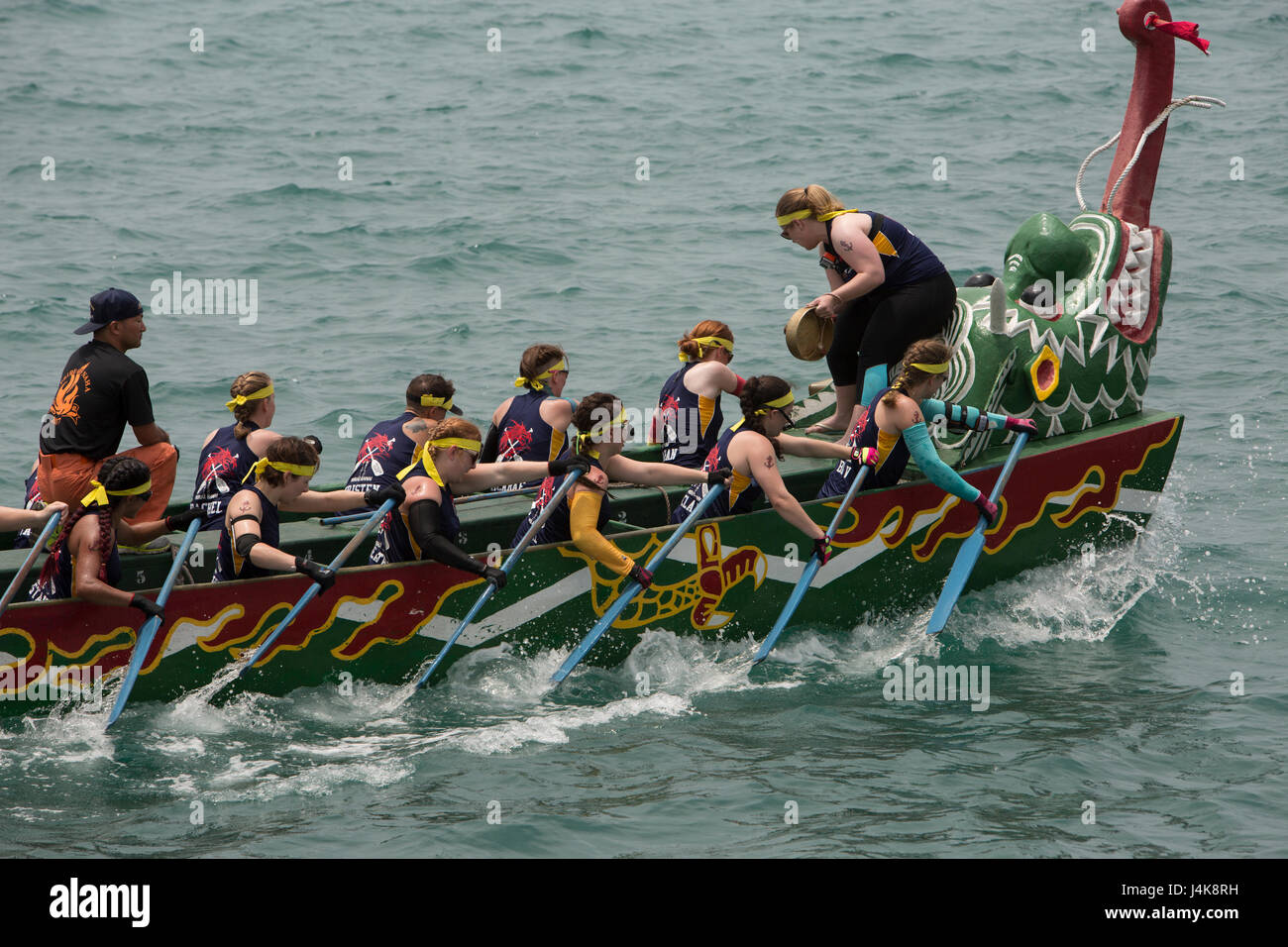 The Navy Women’s dragon boat team fights to win the race during the 43rd Naha Harii Festival 2017’s Dragon Boat races May 5 in Naha City, Okinawa, Japan. The Navy, Air Force and Army women’s teams battled it out. They trained months prior to this, working on their strength, speed and staying in sync with each other. These races require teamwork and staying in sync for the most speed and power to win. Stock Photo