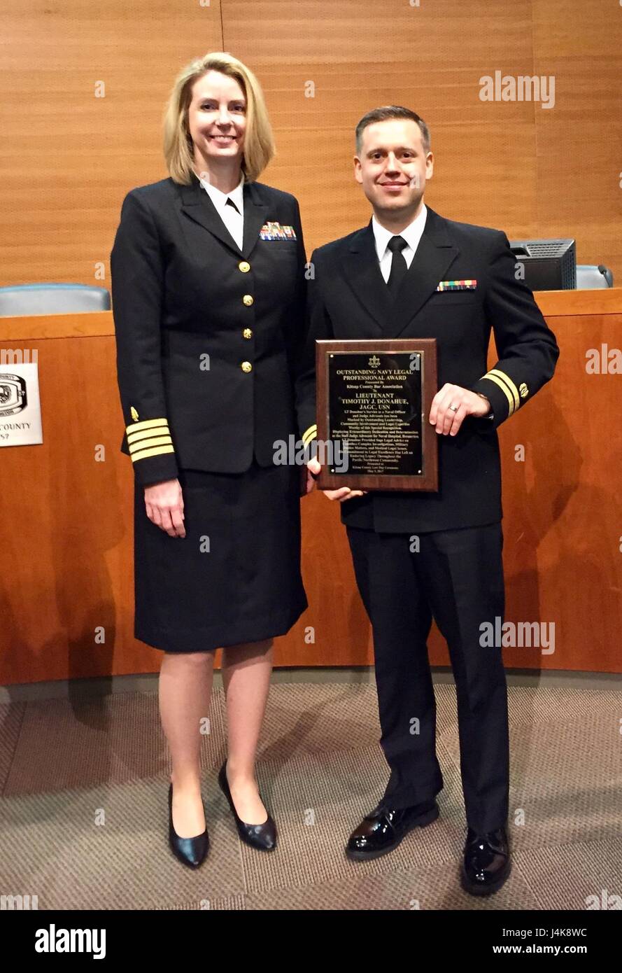 For a judicial job well done...Lt. Timothy J. Donahue, Judge Advocate  General Corps, accepts thanks from Capt. Kim Zuzelski, Naval Hospital  Bremerton Executive Officer, upon receiving the 'Outstanding Navy Legal  Professional Award' from the Kitsap County Bar Association on May 5, 2017  (Courtesy photo). Stock Photo