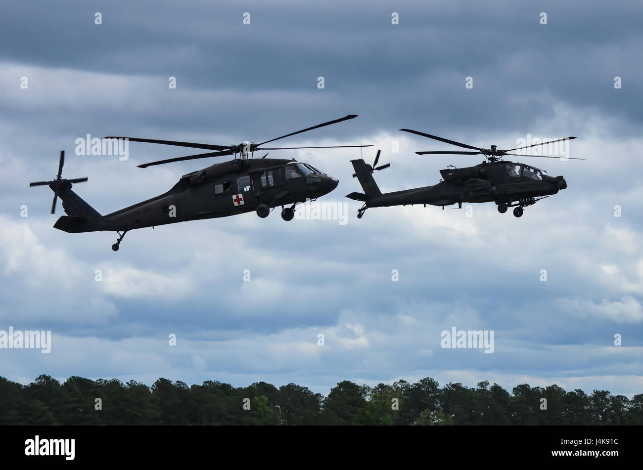 An AH-64 Apache and a UH-60 Black Hawk fly during the South Carolina  National Guard Air and Ground Expo at McEntire Joint National Guard Base,  South Carolina, May 5, 2017. This expo