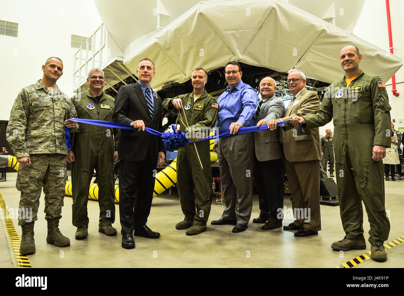 A ribbon is cut to signify the opening of a KC-135 flight simulator at the 171st Air Refueling Wing near Pittsburgh Pa. May 5, 2017. Holding the ribbon from left to right is Maj. Jeremy Ketter, Commander of the 171 Civil Engineer Squadron, Brig. Gen. Tony Carrelli, Pennsylvania Adjutant General, Congressman Tim Murphy, representing the 18th district of Pennsylvania, Col. Gregg Perez, 171st Wing Commander, Tim Bush, KC-135 Aviation Training System Operations and Maintenance Program Manager for CAE, Cliff Sanchez, KC-135 Aviation Training System Manager at Air Mobility Command, Rep. Mark Mustio, Stock Photo