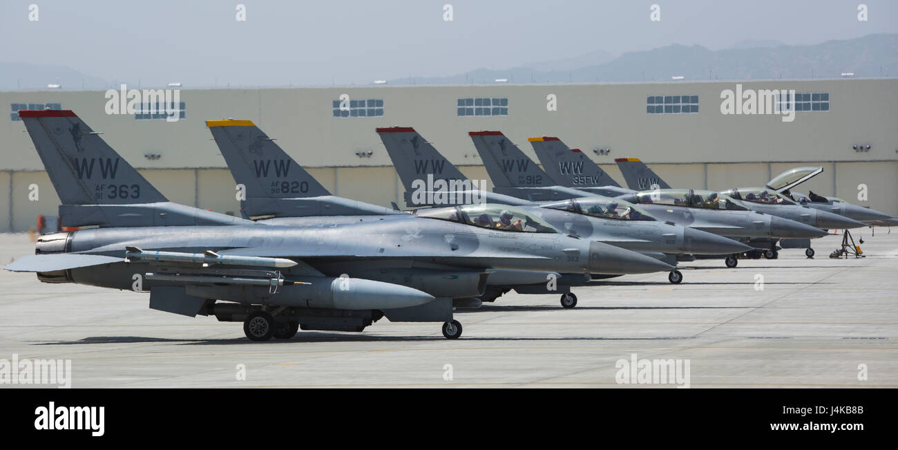 U.S. Air Force F-16 Fighting Falcons with the 14th Fighter Squadron, 35th Operations Group, 35th Fighter Wing from Misawa Air Base, stand by for take off after conducting hot pit refueling at Marine Corps Air Station Iwakuni, Japan, May 8, 2017. Hot pits are refueling stations usually used in combat to rapidly refuel aircraft while the engines are running. This allows aircraft to return to the fight with minimal delay. (U.S. Marine Corps photo by Pfc. Stephen Campbell) Stock Photo
