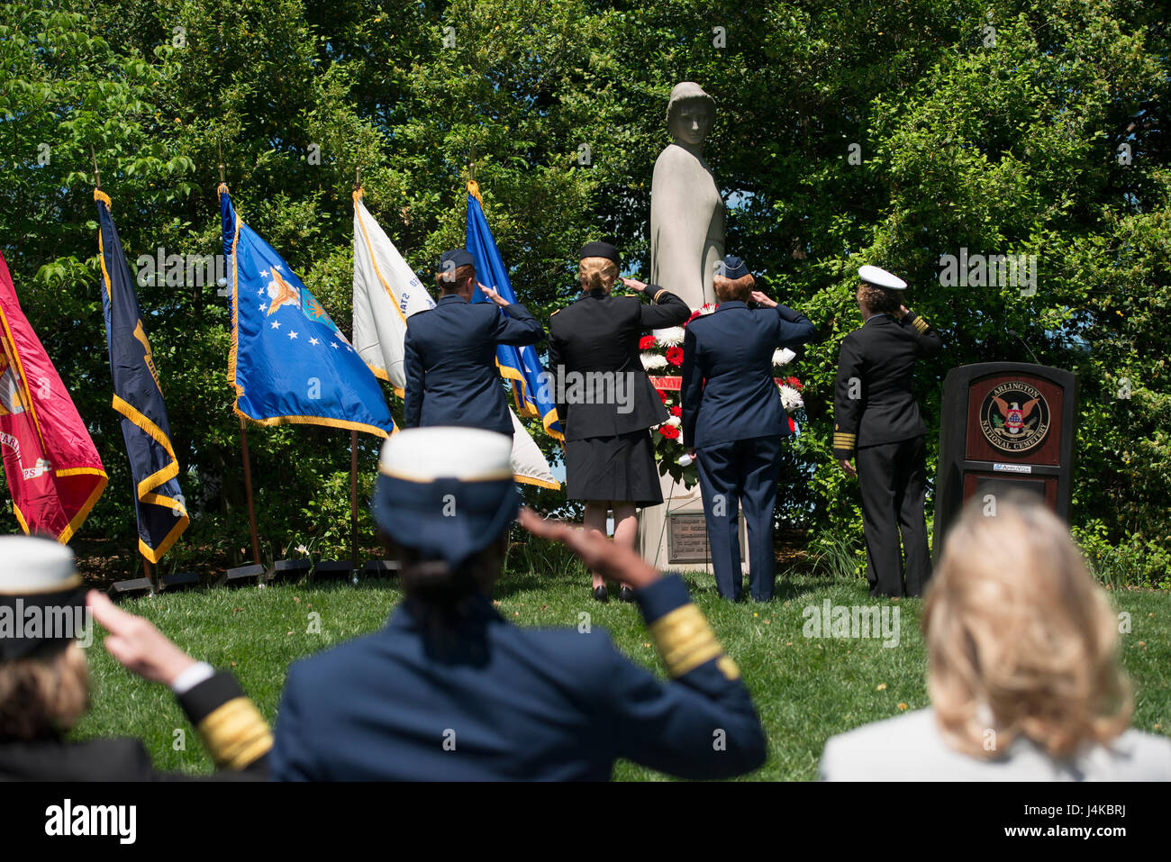 Col. Maggie Jones, deputy chief of nurses, Air Force, Col. Sandra McNaughton, senior nurse analyst, Defense Health Agency, Maj. Gen. Dorothy Hogg, deputy surgeon general and chief, Air Nurse Corps, and Capt. Deborah Roy, deputy chief of nurses, Navy, salute the Nurses Memorial during a wreath laying ceremony at Arlington National Cemetery in Virginia for National Nurses Week, May 8, 2017. Erected in 1938, the granite statue honors the nurses who served in the U.S. armed forces in World War I.  (U.S. Army photo by Elizabeth Fraser/Arlington National Cemetery/Released) Stock Photo