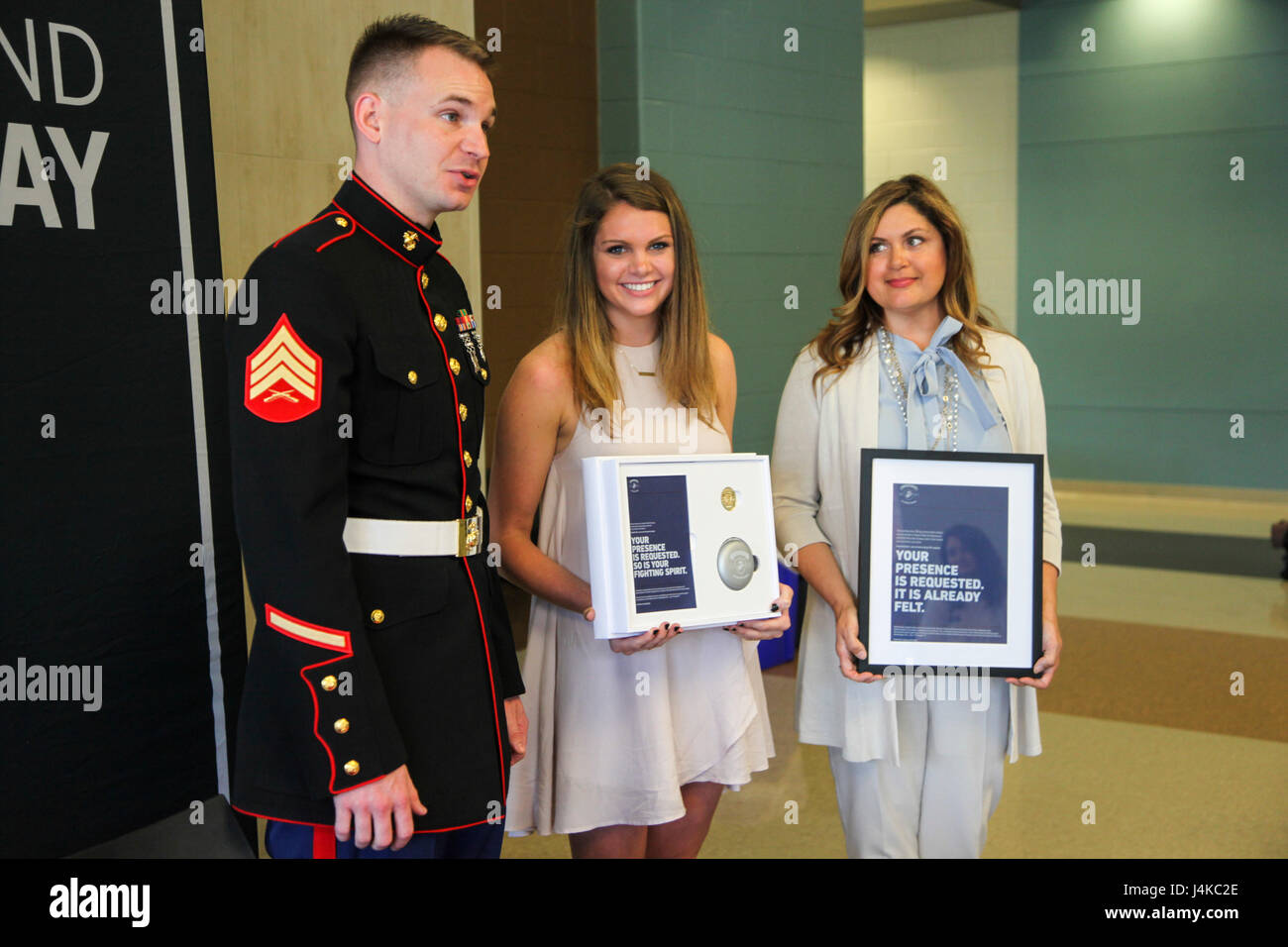 U.S. Marine Sgt. Roderick Evans presents Natasha Kusibab and her mentor ...