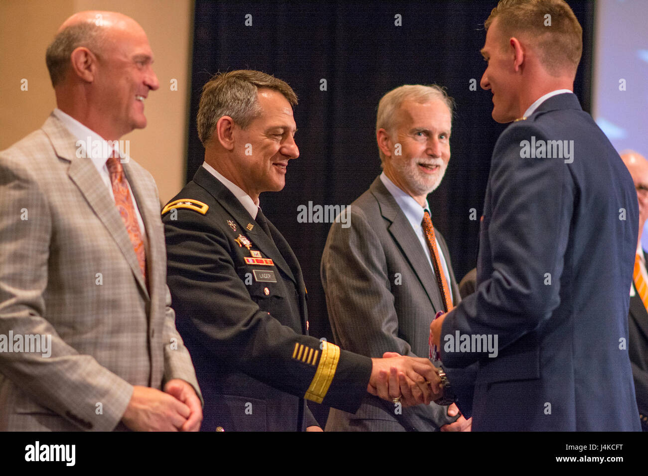 U.S. Army Maj. Gen. James B. Linder, commander of the U.S. Army John F. Kennedy Special Warfare Command, congratulates brand new 2nd Lt. Sean Mac Lain during Clemson University’s Reserve Officers’ Training Corps commissioning ceremony, May 10, 2017. Mac Lain was a member of both the 2016 Clemson Tigers National Football Championship team and the Clemson ROTC Pershing Rifles 2016 national champion drill and ceremony team. (U.S. Army Reserve photo by Staff Sgt. Ken Scar) Stock Photo
