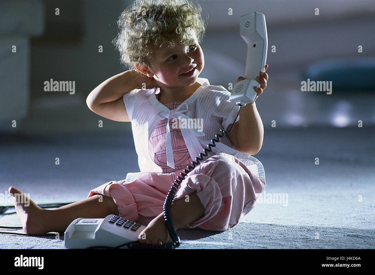 Infant, floor, sit, call up at home, baby, child, girl, smile, play childhood, phone, apparatus, pushbutton telephone, fixed network, receiver, Stock Photo