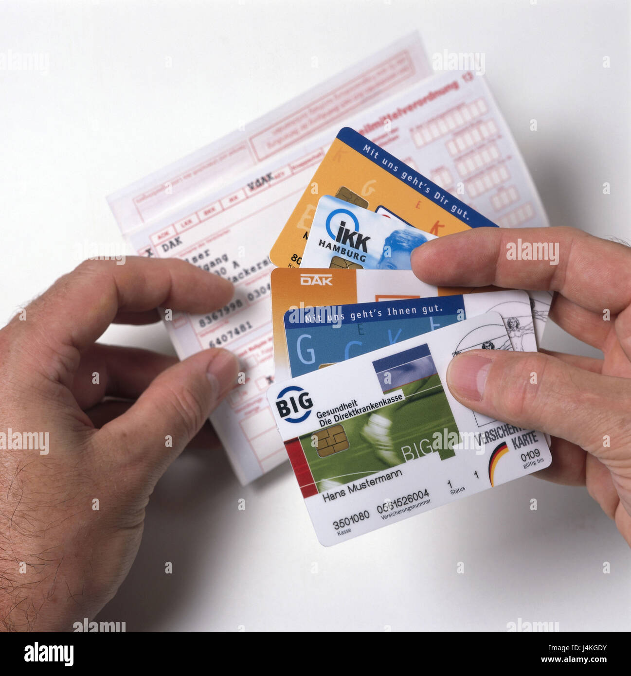 Man, detail, hands, recipe light, insurance cards health insurance, health insurance cards, cards, chip cards, health insurances, health insurance, ill-insured, privately, private-insured, recipe, drug order, recipe fee, public health, disease, expenses, liable to prescription, man's hands Stock Photo