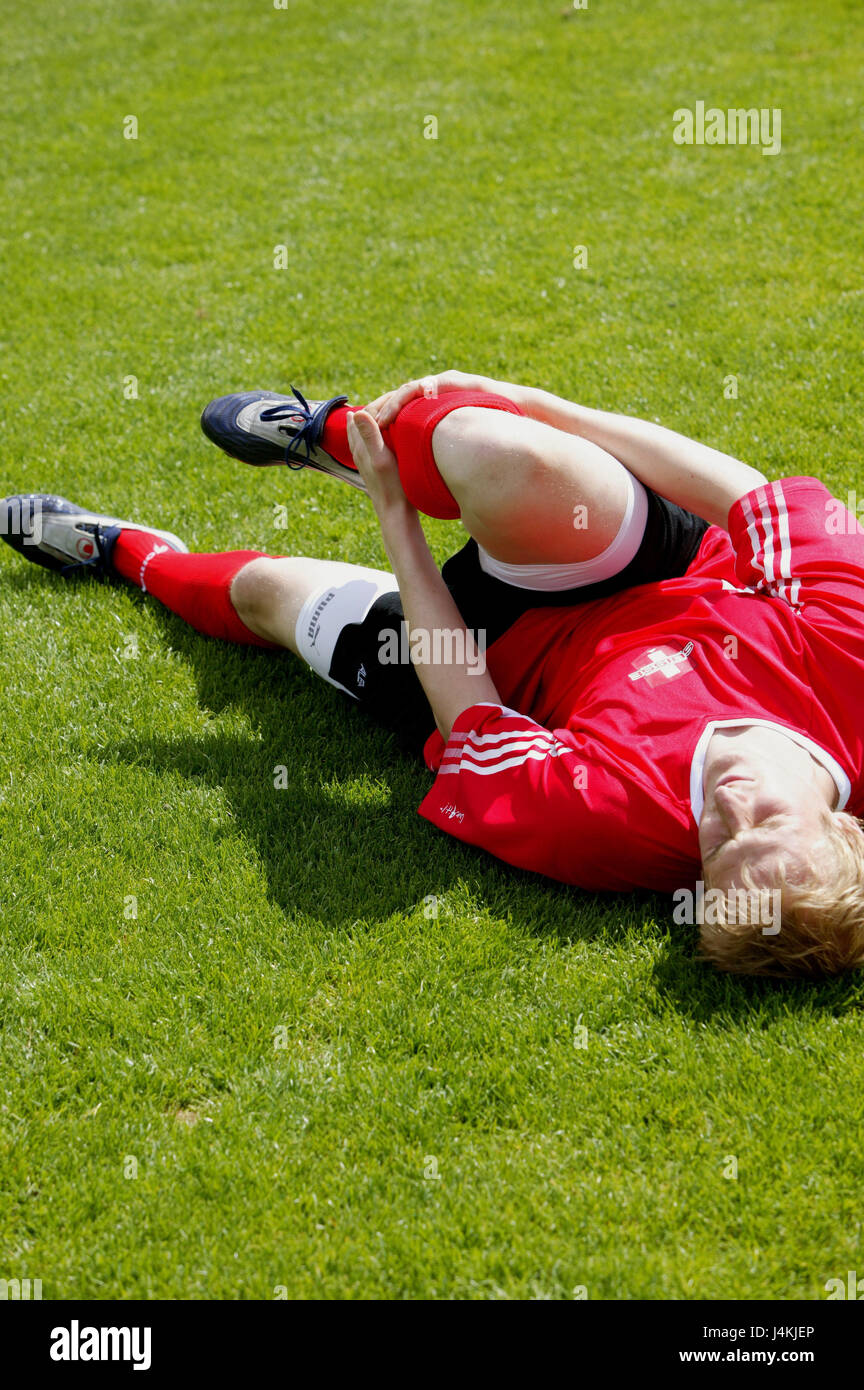 Turfs, football players, lie, hold shank, pains football match, man