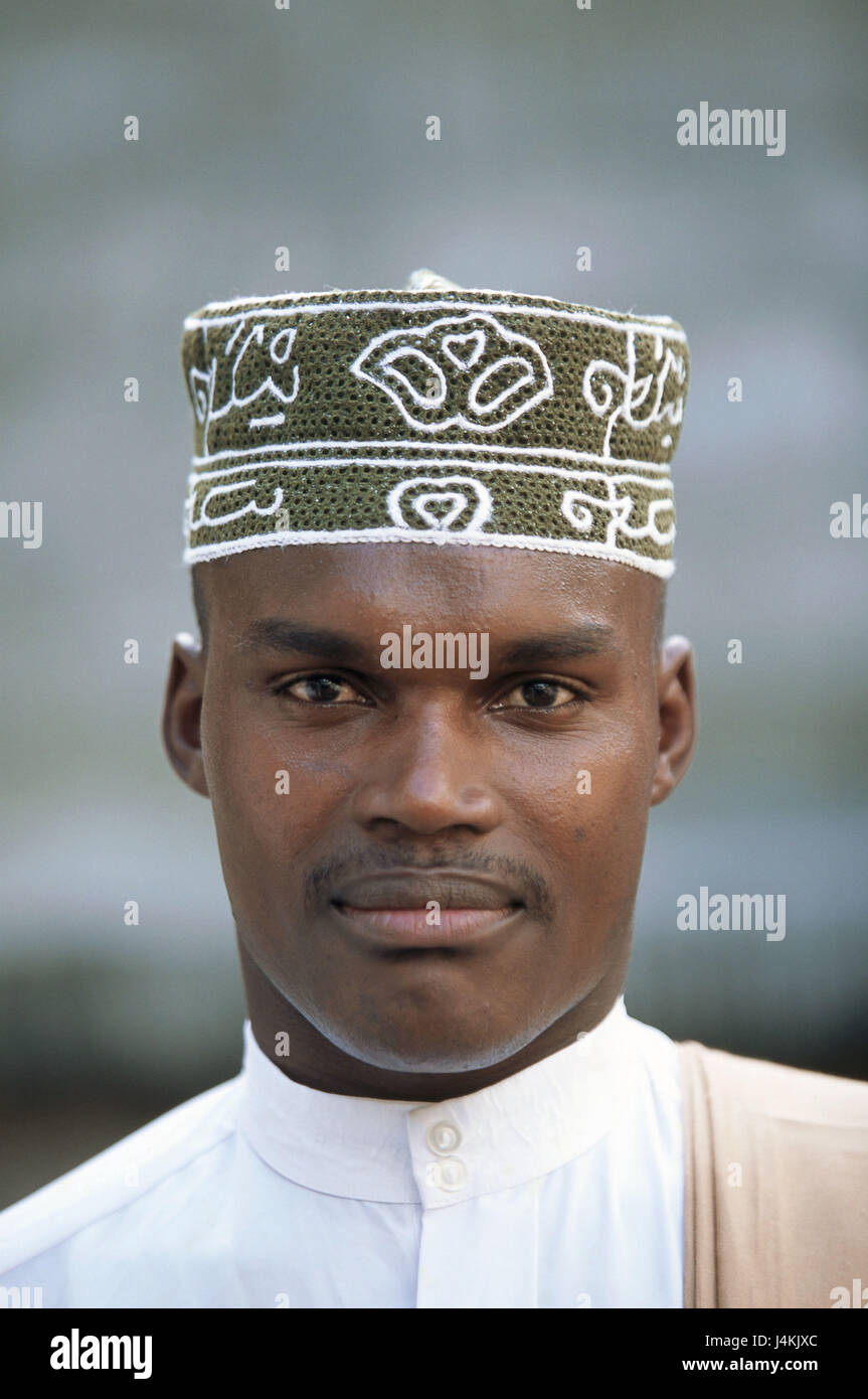 The Comoro Archipelago, island Anjouan, Mutsamudu, man, young, cap, portrait no model release! Africa, Indian ocean, island state, Nzwani, man's portrait, young, non-white, swarthy, swarthy, local, headgear, traditionally, tradition, faith, religion, religiously, Moslem, Islamic, Islam, view camera Stock Photo
