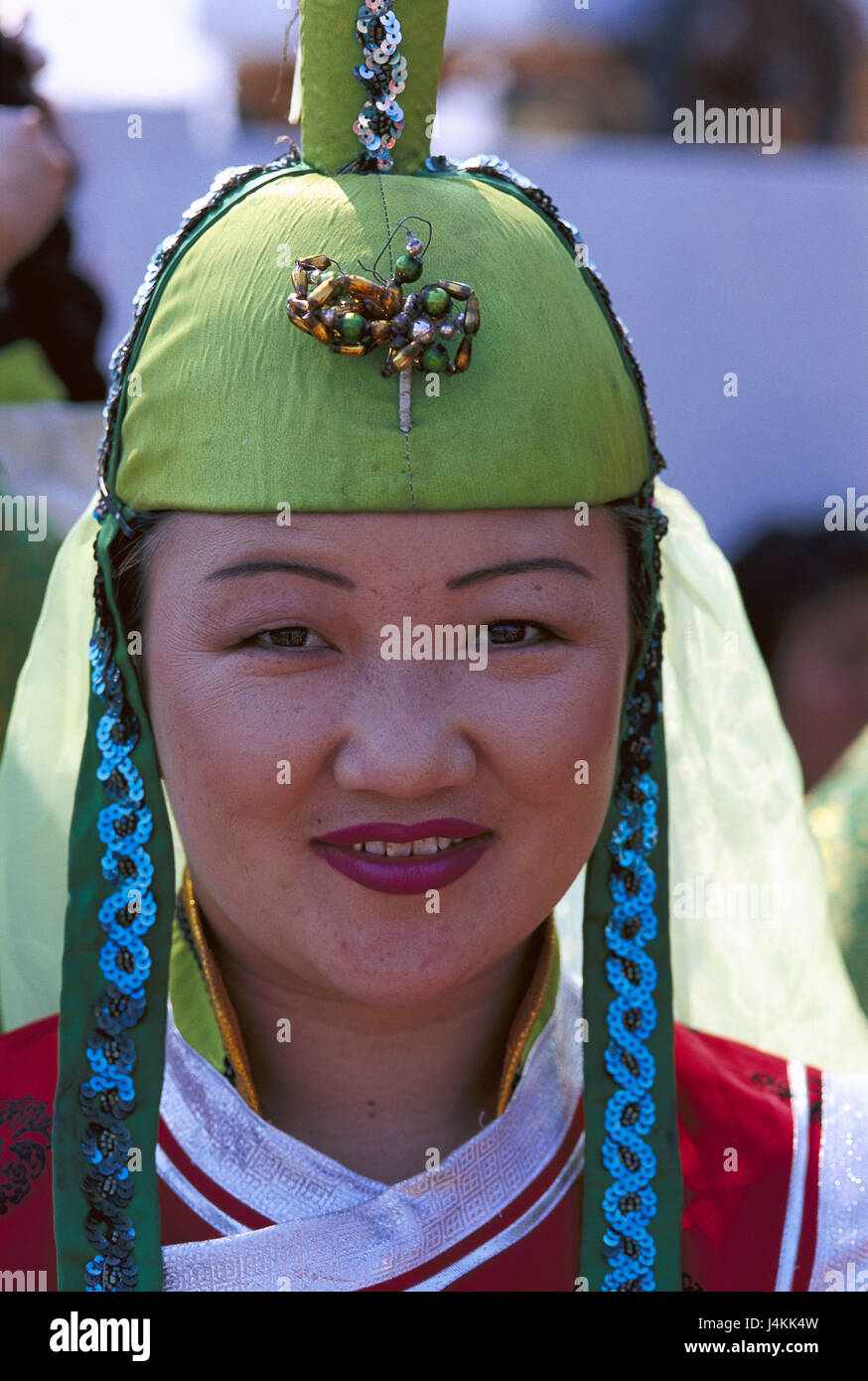 Mongolia, Ulan Bator, Naadam feast, woman, holiday national costume, portrait no model release Central Asia, local, Mongol, national costume, folklore, folklore clothes, headgear, view camera, smile, holiday national costume, tradition, traditions, feast, Staatsnaadam, event, summer Stock Photo