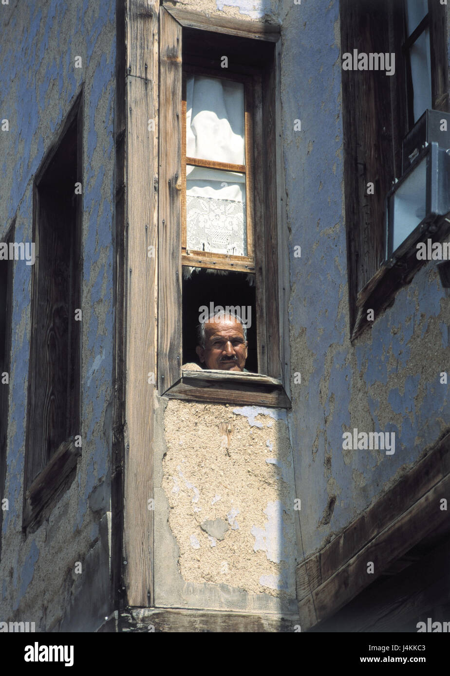 Turkey, Anatolia, house facade, man, view window no model release! People, in Turkish, Turk, middle old person, house, facade, view, curiosity, interest, attention, foreigner, foreign worker, south countries, homes, native country, light, shade Stock Photo