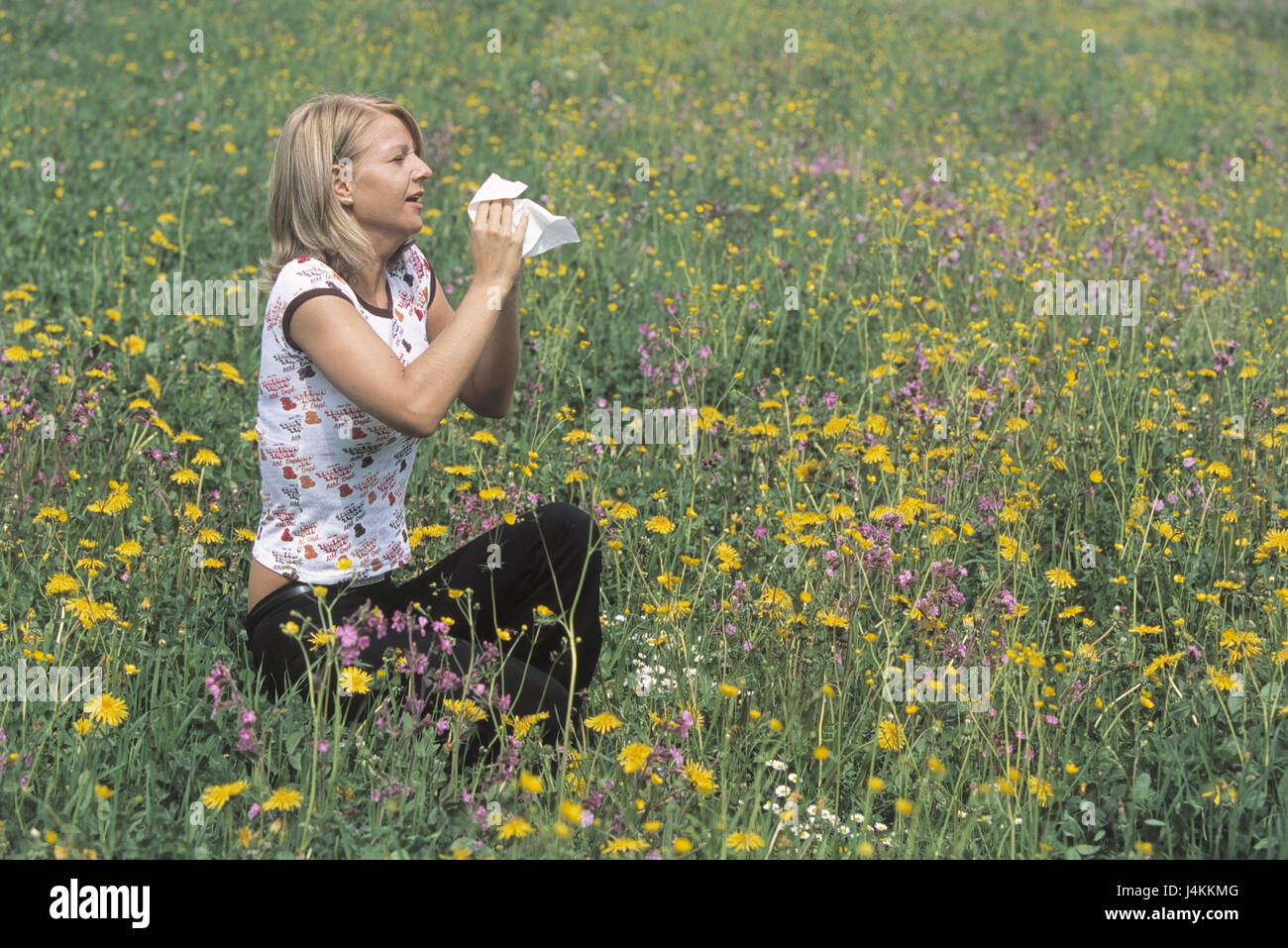 Flower meadow, woman, young, pollinosises, sneeze, clean handkerchief summer, spring, meadow, flowers, blossoms, polling flight, polling, pollen, Allergikerin, allergy, polling allergy, irritation, reaction, allergically, to walrus moustaches, allergens, flower pollings, polling allergy, disease, nose, coryza, grip, cold, outside Stock Photo