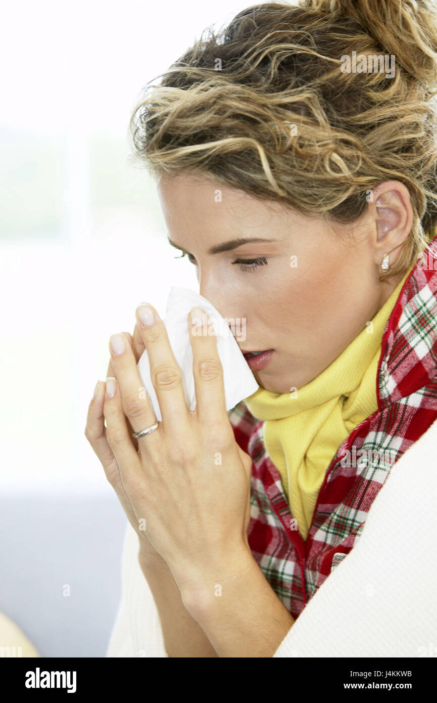 Woman, sneeze young, ill, handkerchief, portrait, at the side , women's portrait, 20-30 years, blond, locks, hairs tied back, sleep suit, ceiling, scarf, cold, disease, grippaler infection, sore throat, coryza, nose to walrus moustaches, inside, at home Stock Photo